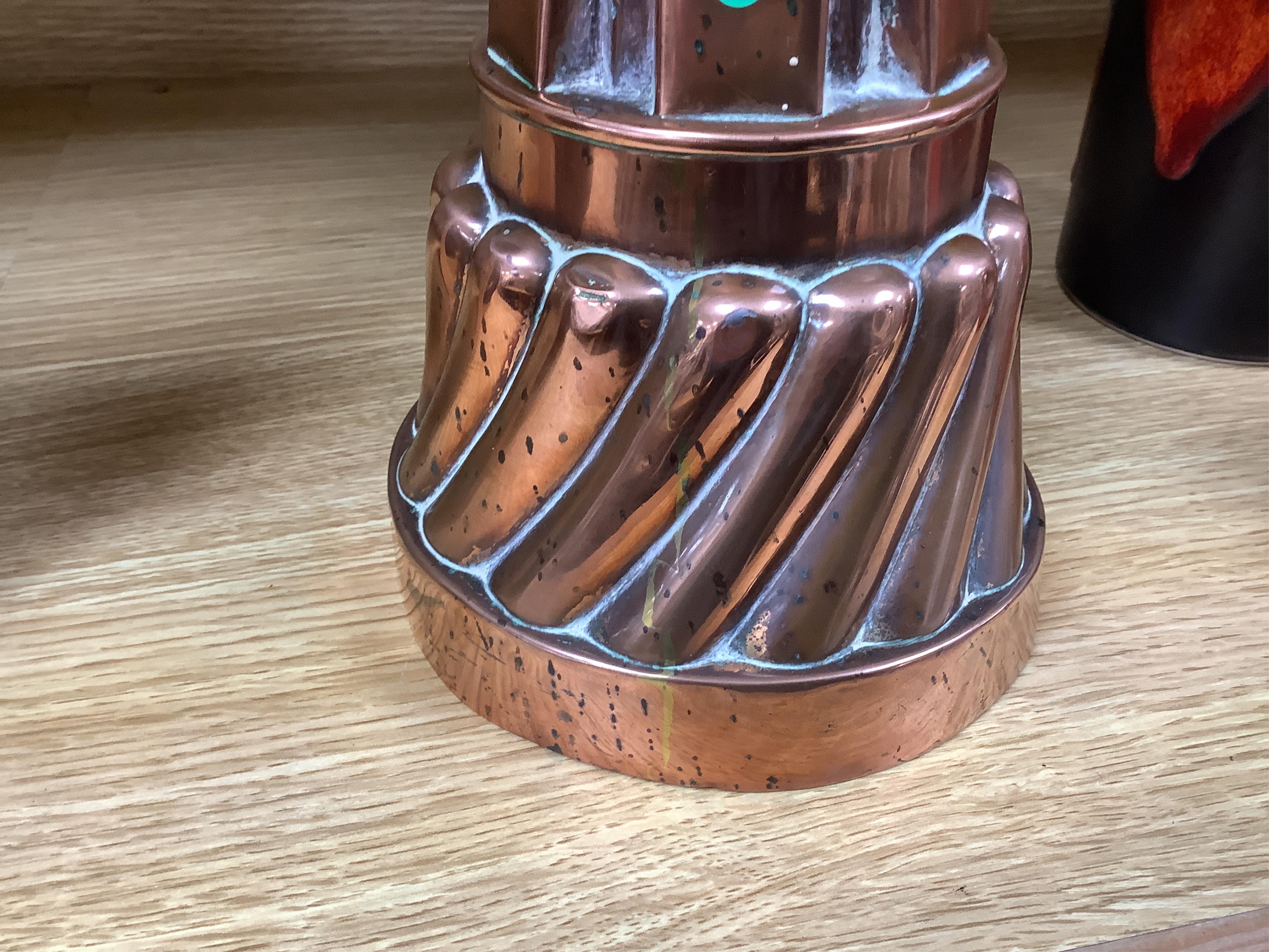 A tall Victorian copper jelly mould, 17cm. Condition - fair